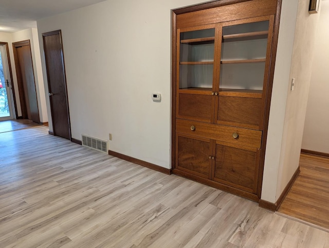 1437 S Plum Ave, Freeport, IL 61032 - unfurnished dining area with baseboards and light wood-style floors