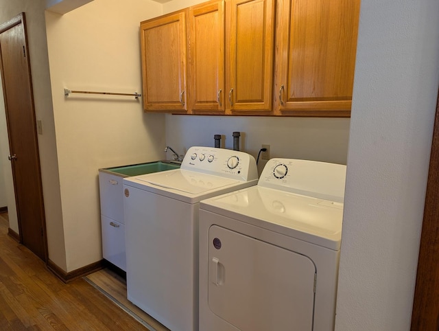 1437 S Plum Ave, Freeport, IL 61032 - washroom with cabinet space, wood finished floors, and separate washer and dryer