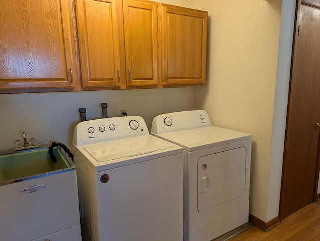 1437 S Plum Ave, Freeport, IL 61032 - laundry room featuring washing machine and dryer, cabinet space, and light wood-type flooring