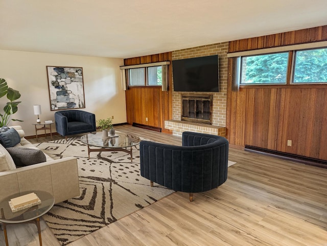 1437 S Plum Ave, Freeport, IL 61032 - living area featuring wood finished floors, a fireplace, wooden walls, and a baseboard radiator