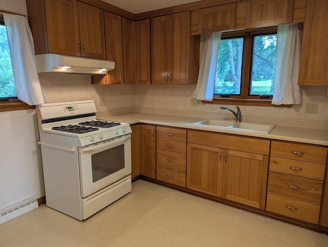 1437 S Plum Ave, Freeport, IL 61032 - kitchen featuring gas range gas stove, under cabinet range hood, baseboard heating, and light countertops