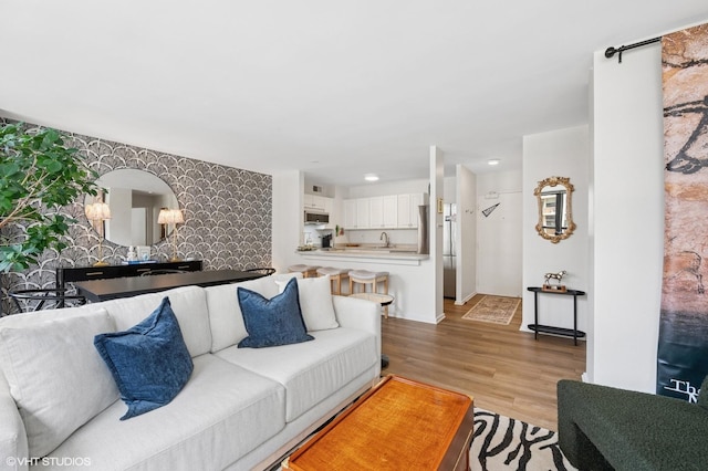 33 E Cedar St Unit 8G, Chicago, IL 60611 - living room featuring light wood finished floors, wallpapered walls, and an accent wall
