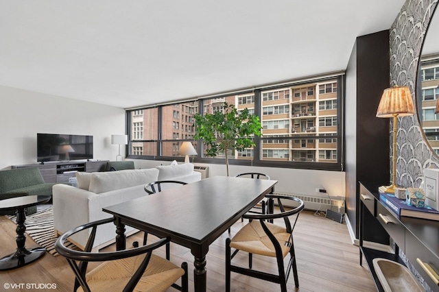 33 E Cedar St Unit 8G, Chicago, IL 60611 - dining room featuring light wood-type flooring and an AC wall unit