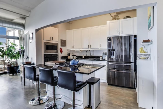 1530 S State St Unit 14O, Chicago, IL 60605 - kitchen featuring black appliances, decorative backsplash, white cabinetry, dark countertops, and a breakfast bar area