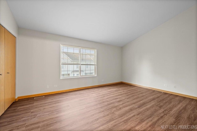 1916 Middlebury Dr Unit 1916, Aurora, IL 60503 - unfurnished bedroom featuring wood finished floors and a closet