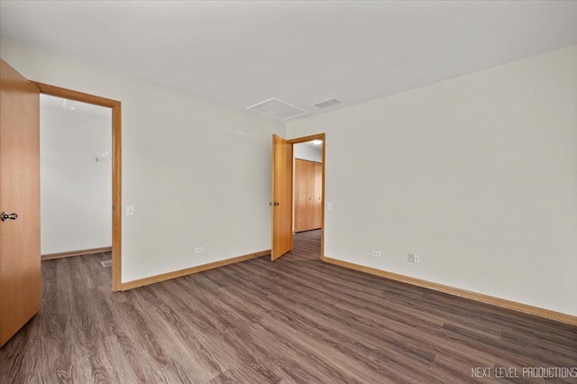 1916 Middlebury Dr Unit 1916, Aurora, IL 60503 - spare room featuring wood finished floors and attic access