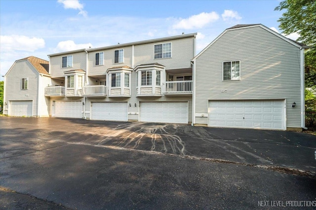 1916 Middlebury Dr Unit 1916, Aurora, IL 60503 - rear view of house with driveway and a garage