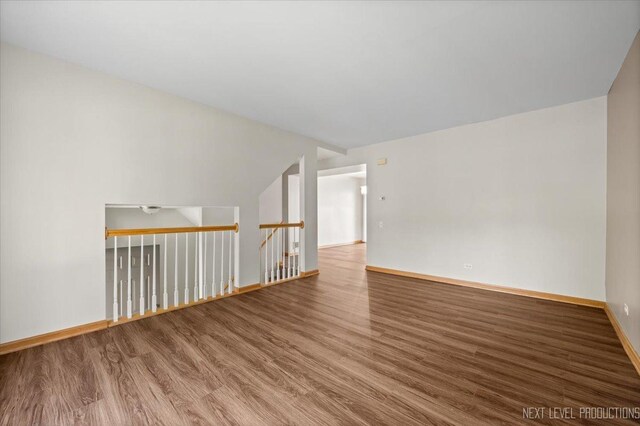 1916 Middlebury Dr Unit 1916, Aurora, IL 60503 - spare room featuring wood finished floors and lofted ceiling