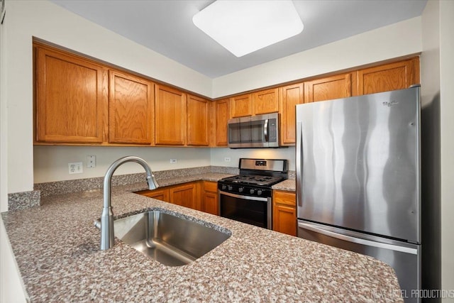1916 Middlebury Dr Unit 1916, Aurora, IL 60503 - kitchen with appliances with stainless steel finishes, brown cabinetry, and stone countertops