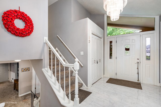 20131 E Brightway Dr, Mokena, IL 60448 - foyer featuring a chandelier, stairway, a textured ceiling, and vaulted ceiling