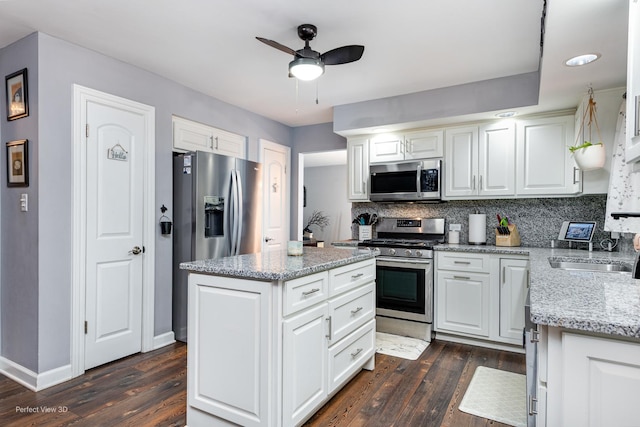 20131 E Brightway Dr, Mokena, IL 60448 - kitchen with stainless steel appliances, a ceiling fan, dark wood-type flooring, white cabinets, and decorative backsplash