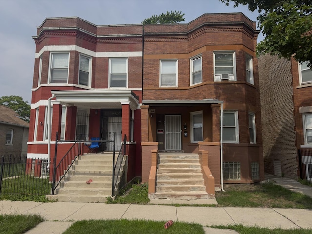 7042 S Carpenter St, Chicago, IL 60621 - multi unit property featuring brick siding, a porch, and cooling unit