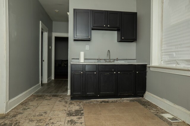 7042 S Carpenter St, Chicago, IL 60621 - kitchen featuring light countertops and dark cabinetry