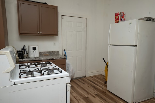 7042 S Carpenter St, Chicago, IL 60621 - kitchen featuring white appliances, light wood-type flooring, and gray cabinetry