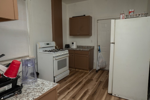 7042 S Carpenter St, Chicago, IL 60621 - kitchen with white appliances, light wood finished floors, and light countertops
