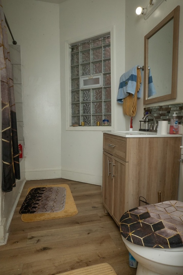 7042 S Carpenter St, Chicago, IL 60621 - full bathroom featuring vanity, wood finished floors, and a shower