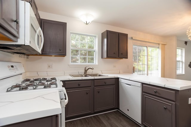 10 Sugar Creek Ct, Lake In The Hills, IL 60156 - kitchen with white appliances, a peninsula, dark wood finished floors, dark brown cabinetry, and light stone counters