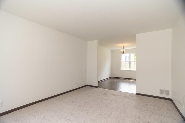 10 Sugar Creek Ct, Lake In The Hills, IL 60156 - carpeted spare room with a chandelier and baseboards