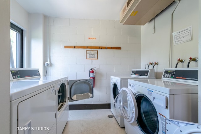 shared laundry room with separate washer and dryer