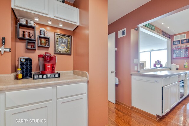 kitchen featuring light wood-type flooring, white cabinetry, and light countertops