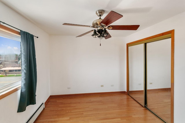9407 S Roberts Rd Unit 3Se, Hickory Hills, IL 60457 - unfurnished bedroom featuring a baseboard heating unit, light wood-type flooring, a closet, and a ceiling fan