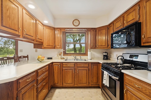 2619 Baldwin Rd, Mchenry, IL 60050 - kitchen with stainless steel range with gas cooktop, black microwave, brown cabinetry, and recessed lighting