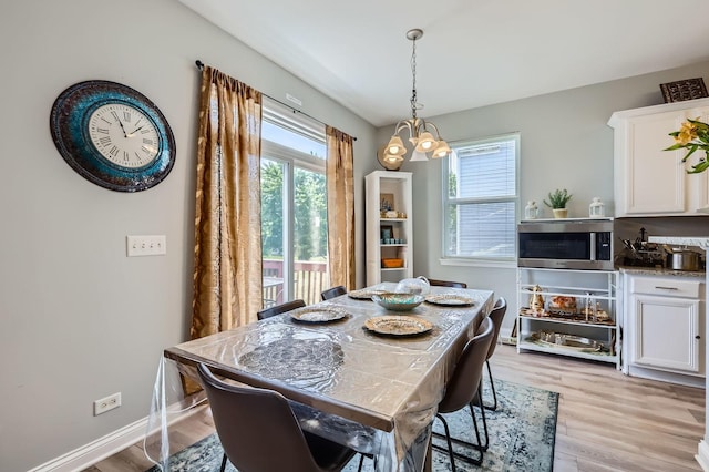 233 Pawtucket Ave, Elgin, IL 60124 - dining space with a chandelier and light wood-type flooring