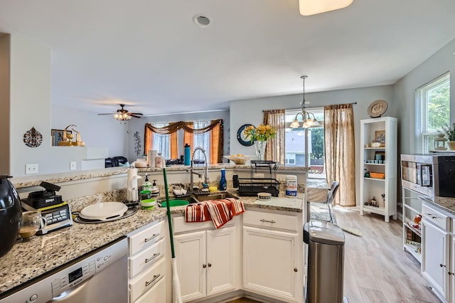 233 Pawtucket Ave, Elgin, IL 60124 - kitchen with stainless steel dishwasher, white cabinetry, light wood-style floors, hanging light fixtures, and light stone counters