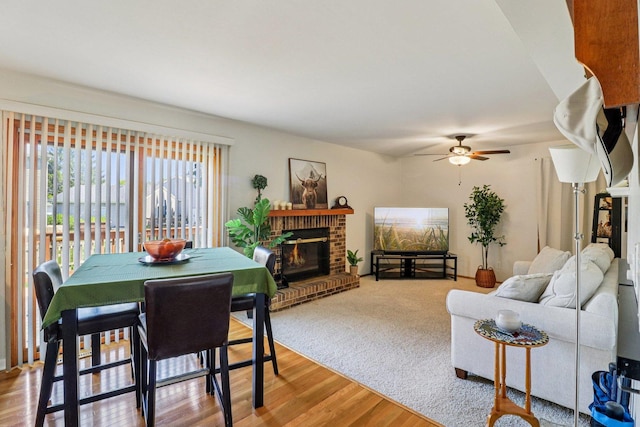 5506 W Chasefield Cir, Mchenry, IL 60050 - living area featuring a ceiling fan, a brick fireplace, and wood finished floors