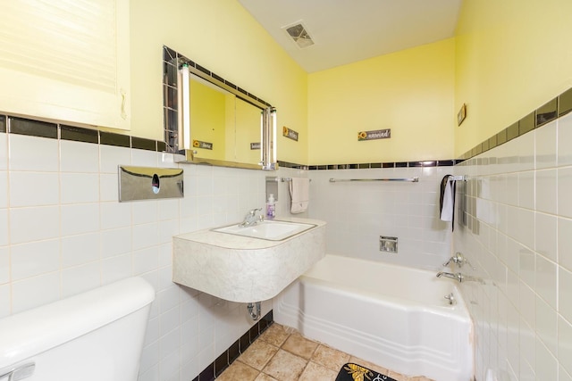 1014 N Main St, Pontiac, IL 61764 - full bath featuring tile walls, a tub to relax in, and wainscoting