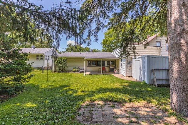 1014 N Main St, Pontiac, IL 61764 - rear view of property featuring a lawn and a patio