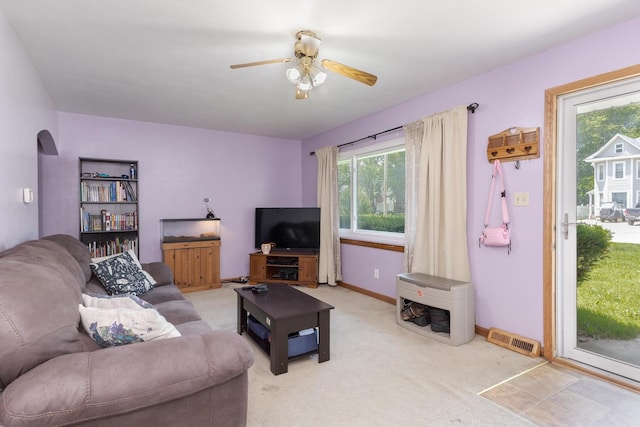 1014 N Main St, Pontiac, IL 61764 - living room with a ceiling fan, light carpet, and arched walkways