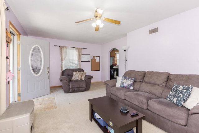 1014 N Main St, Pontiac, IL 61764 - living area featuring arched walkways, a ceiling fan, and light colored carpet