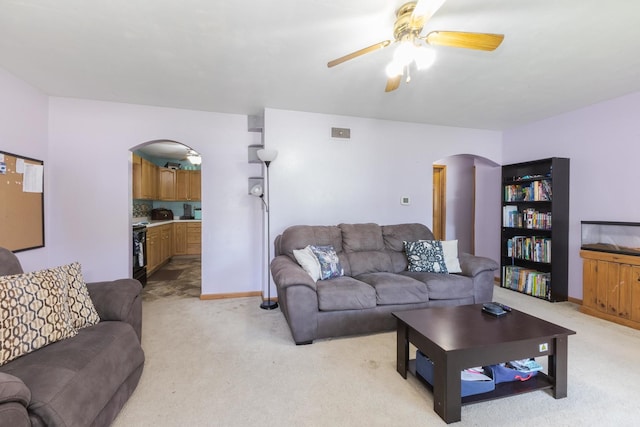 1014 N Main St, Pontiac, IL 61764 - living room featuring arched walkways, a ceiling fan, and light colored carpet