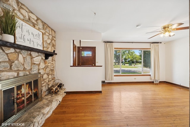 1400 Boeger Ave, Westchester, IL 60154 - unfurnished living room featuring wood-type flooring, a ceiling fan, and a fireplace