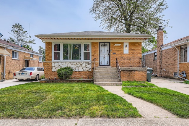 14433 Woodlawn Ave, Dolton, IL 60419 - view of front facade featuring a front lawn, covered porch, and brick siding