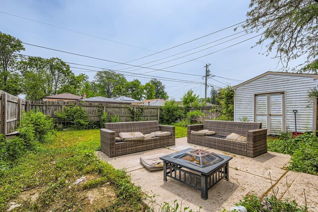 14433 Woodlawn Ave, Dolton, IL 60419 - fenced backyard featuring a patio and an outdoor living space with a fire pit