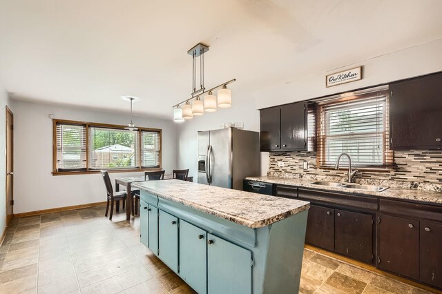 14433 Woodlawn Ave, Dolton, IL 60419 - kitchen with stainless steel fridge, a kitchen island, backsplash, light countertops, and dishwashing machine