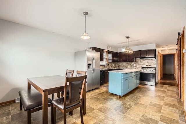 14433 Woodlawn Ave, Dolton, IL 60419 - kitchen featuring appliances with stainless steel finishes, light countertops, tasteful backsplash, a center island, and blue cabinetry