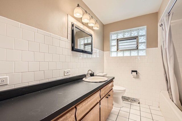 14433 Woodlawn Ave, Dolton, IL 60419 - full bath with tile patterned floors, tile walls, vanity, shower / bath combo, and wainscoting