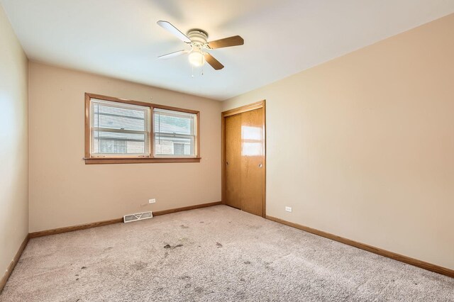 14433 Woodlawn Ave, Dolton, IL 60419 - empty room featuring ceiling fan and carpet flooring