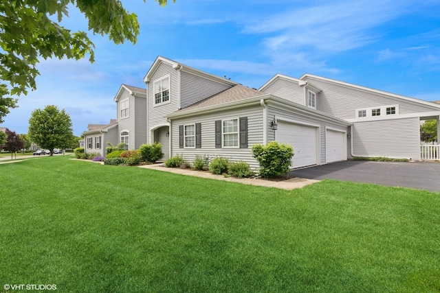 406 Cascade Ln Unit 406, Oswego, IL 60543 - view of front of home featuring a garage, driveway, and a front yard