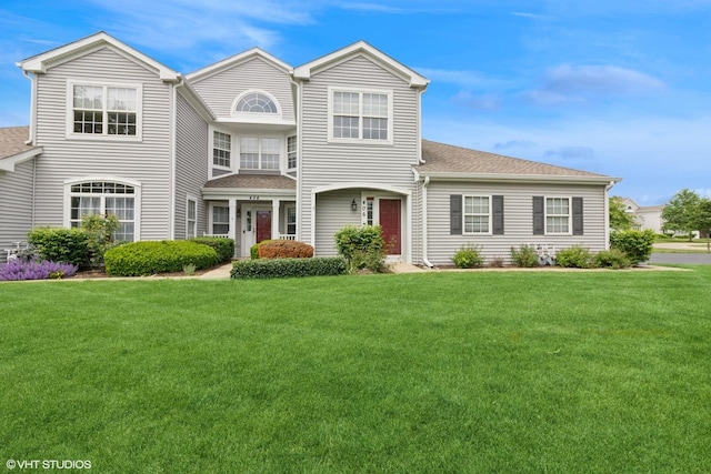 406 Cascade Ln Unit 406, Oswego, IL 60543 - view of front of home featuring a front yard and a shingled roof