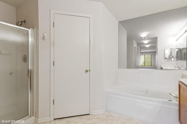 406 Cascade Ln Unit 406, Oswego, IL 60543 - full bathroom featuring a stall shower, vanity, and a garden tub