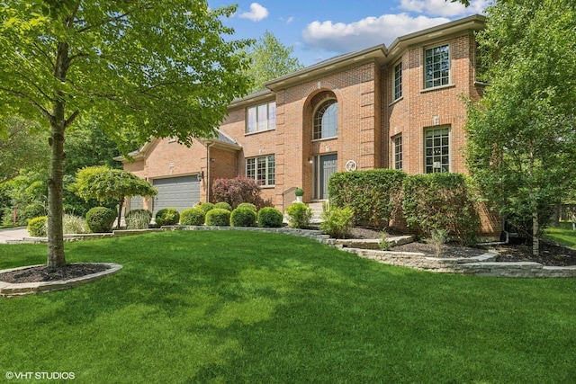 8736 Shade Tree Cir, Lakewood, IL 60014 - view of front of property with a front lawn, an attached garage, and brick siding