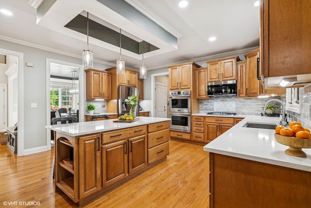 8736 Shade Tree Cir, Lakewood, IL 60014 - kitchen with appliances with stainless steel finishes, a kitchen island, ornamental molding, light wood-type flooring, and light countertops