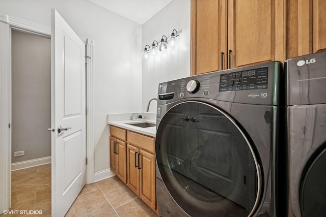 8736 Shade Tree Cir, Lakewood, IL 60014 - laundry room featuring separate washer and dryer, cabinet space, and light tile patterned floors