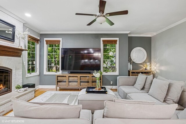 8736 Shade Tree Cir, Lakewood, IL 60014 - living room with wood finished floors, a fireplace, a ceiling fan, and ornamental molding