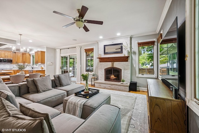 8736 Shade Tree Cir, Lakewood, IL 60014 - living area with crown molding, a ceiling fan, plenty of natural light, a chandelier, and light wood-type flooring