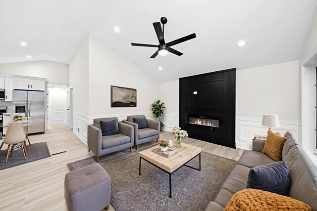 5246 S New England Ave, Chicago, IL 60638 - living room featuring light wood-style flooring, a ceiling fan, lofted ceiling, a decorative wall, and a wainscoted wall